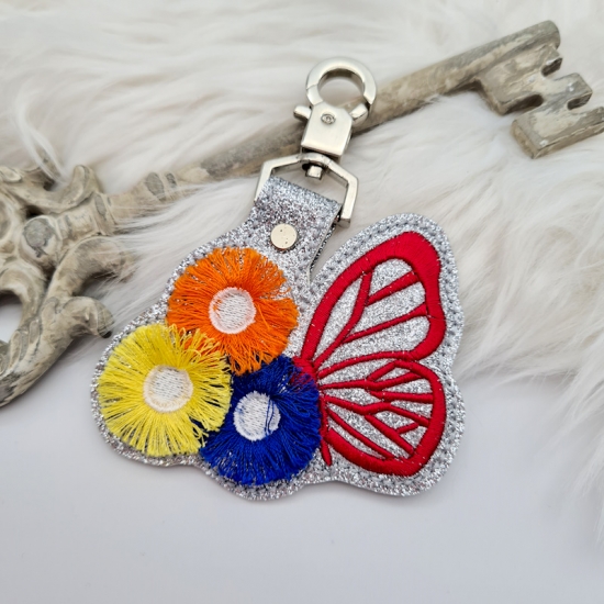 Taschenanhänger / Taschenbaumler Schmetterling mit Blumen silber/rot